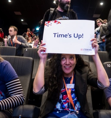 Frontend United 2019 volunteers holding a "Time's Up" sign.